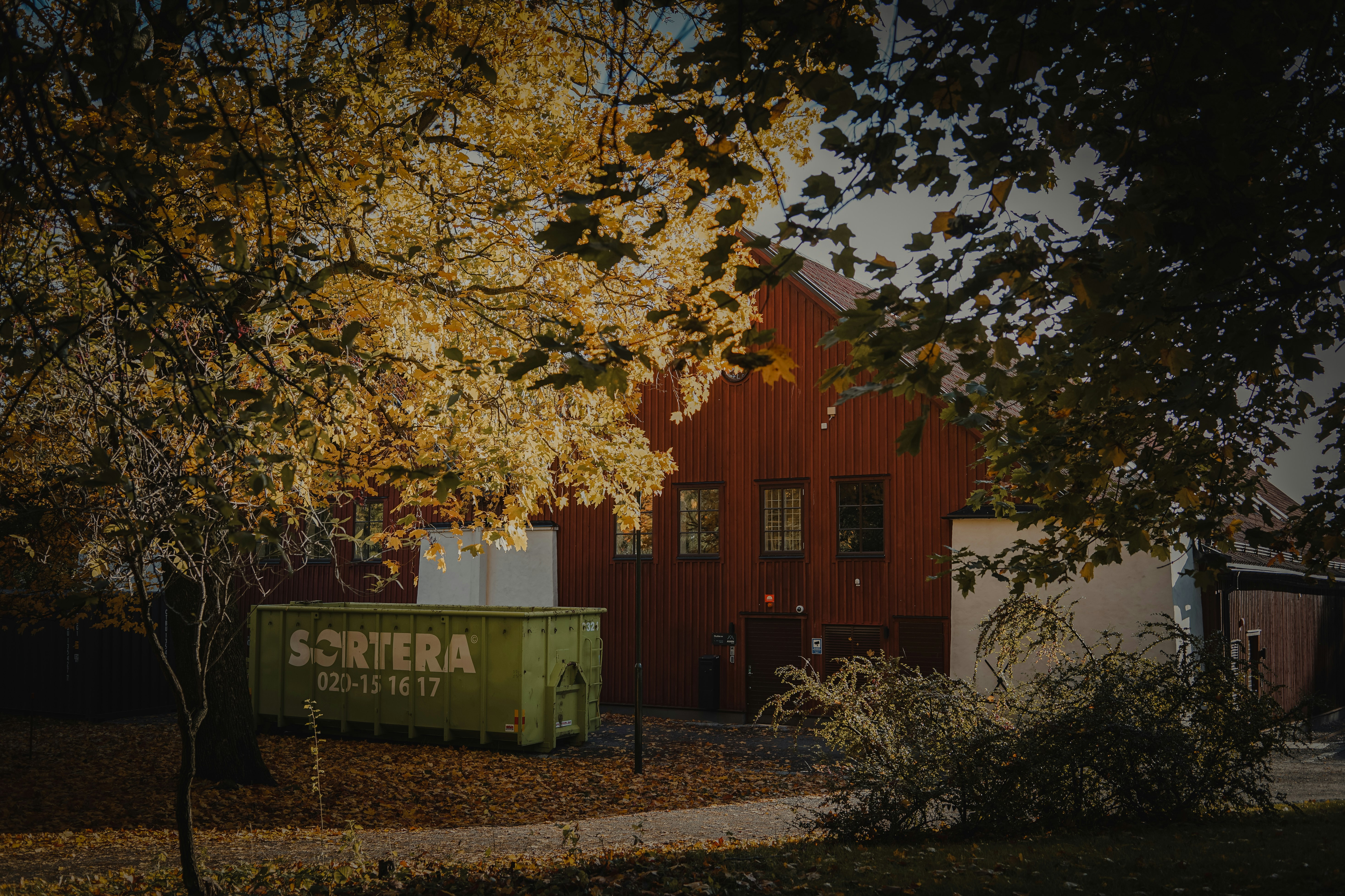 red and white concrete building near green trees during daytime